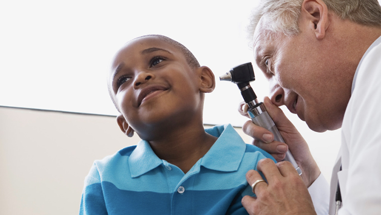 Young boy getting his eyes checked by a doctor.