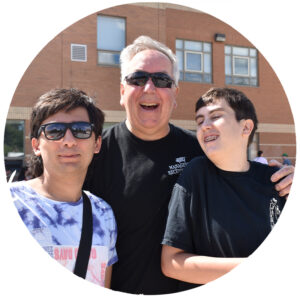 A male teacher with two young male students.